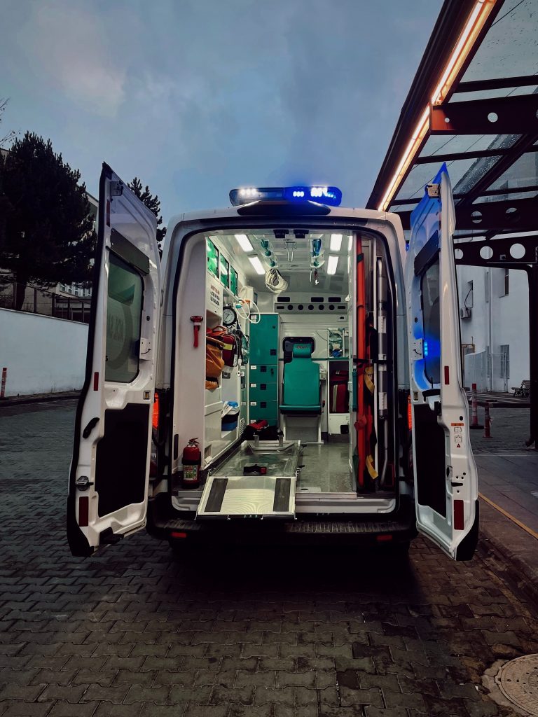 Ambulance with rear doors open to show the inside.